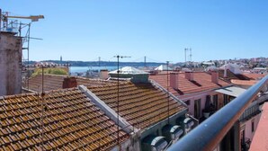 A view of a cityscape with buildings and a bridge in the background. - Spacious Loft w/ City view in Principe Real (Lisboa)
