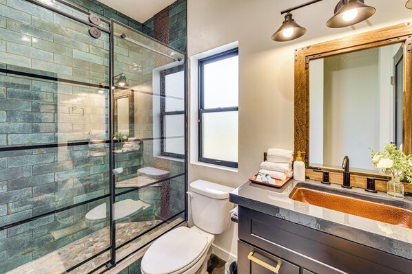 A modern bathroom with a glass-enclosed shower, a white toilet, and a vanity with a large mirror. - 5 Mi to Great Sand Dunes NP: Mountain Retreat! (Mosca)