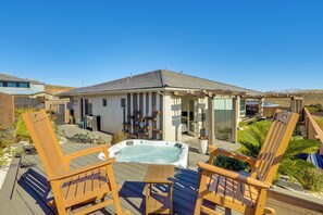 A hot tub on a wooden deck with two wooden chairs, a covered patio area, and a view of a mountainous landscape. - 22 Mi to Zion: Mtn-view 'oasis Sanctuary' (Hurricane)