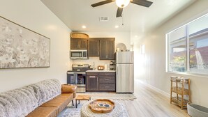 A modern kitchen with dark cabinets, a stainless steel refrigerator, and a microwave. - 22 Mi to Zion: Mtn-view 'oasis Sanctuary' (Hurricane)