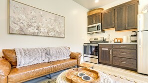 A modern kitchen with dark wooden cabinets, a microwave, oven, and a refrigerator. - 22 Mi to Zion: Mtn-view 'oasis Sanctuary' (Hurricane)