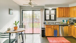 A kitchen with wooden cabinets, a dishwasher, and a dining area with a table and chairs. - 4 Mi to Dtwn: Family Home in Buffalo (Buffalo)