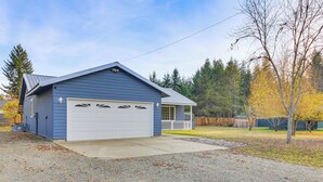 A single-story house with a garage, a front porch, and a driveway. - 8 Mi to Bonners Ferry: Quiet Getaway w/ Patio (Moyie Springs)