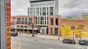 A modern hotel with a brick facade, large windows, and a covered entrance area.