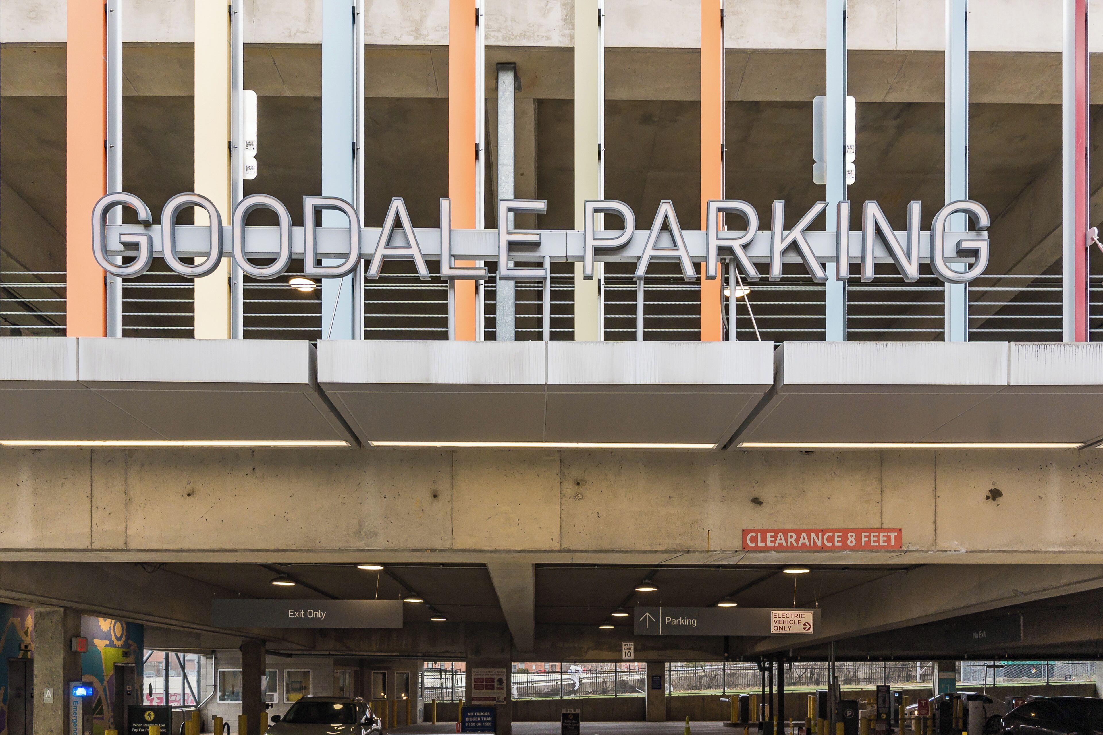 A parking garage entrance with a sign reading "GOODALE PARKING" and a clearance sign indicating "8 FEET".