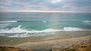 A beach with waves and a cloudy sky. - Villa del Pacifico - Luxury Oceanfront Solana Beach Vacation Rental (Solana Beach)