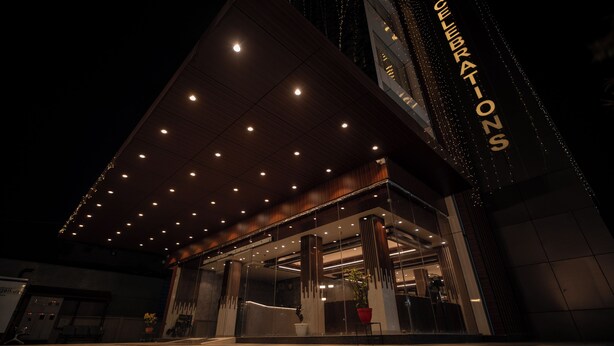 A modern building with a prominent 'COLLABORATION' sign, large windows, and a covered entrance area. - Hotel J.K. Celebration (Jabalpur)