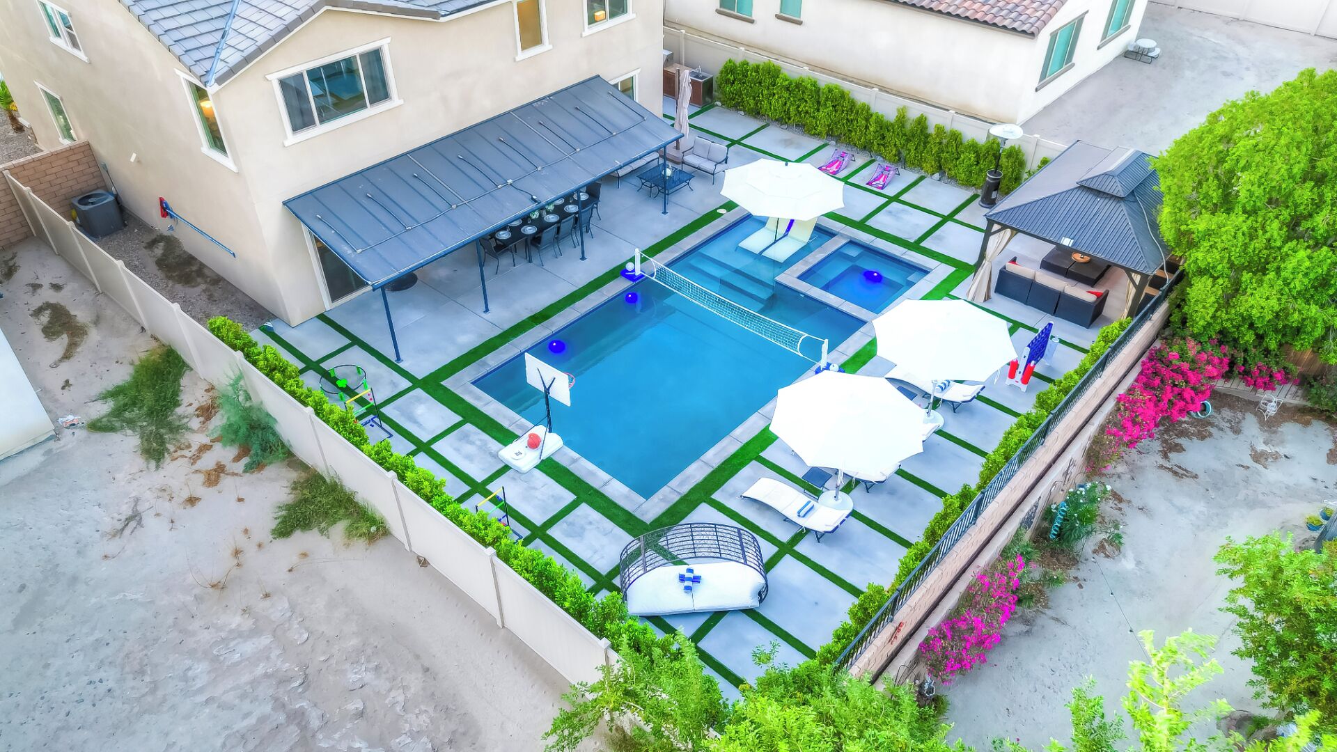 A rooftop pool with a sun terrace, outdoor seating, and a small garden area.
