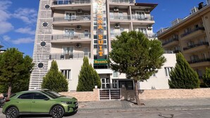 A multi-story hotel with a prominent sign reading "ANASTASIUS HOTEL." - ŞİRİN APARTROOMS (Denizli)