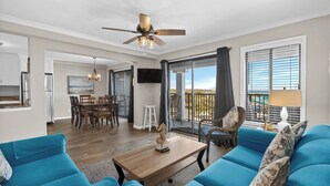 A spacious living room with a balcony, a dining area, and a kitchen. - A421 at Myrtle Beach Resort (Myrtle Beach)