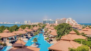 A resort with multiple buildings, a central swimming pool, and a view of the ocean. - Globalstay Luxury Azizi Mina Beachfront  (Dubai)