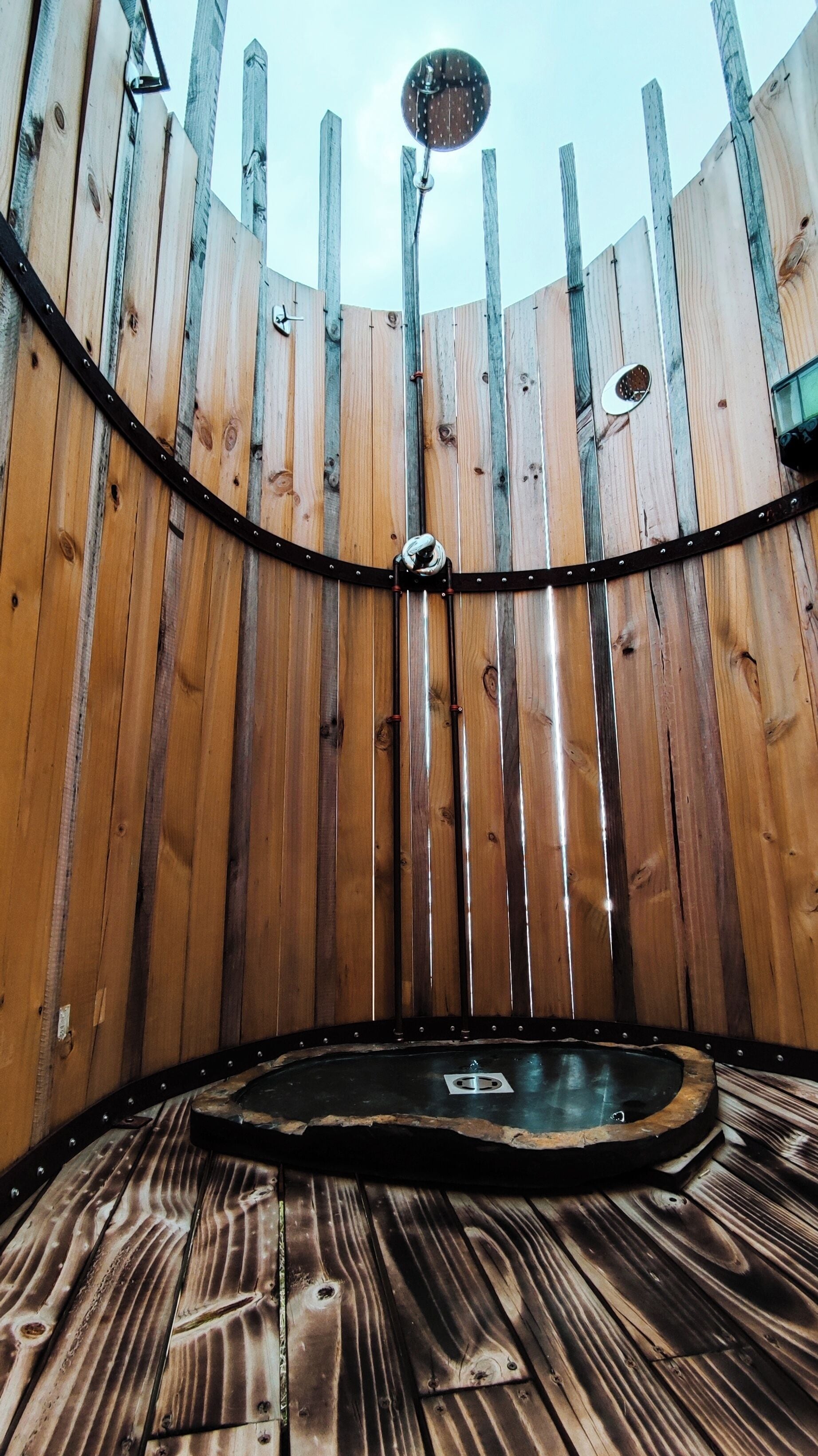 A wooden structure with a circular floor and vertical beams.