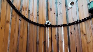 A wooden structure with a circular floor and vertical beams.