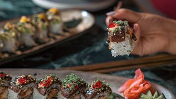 A sushi platter with various types of sushi on a plate.