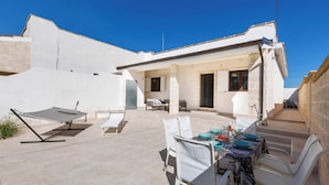 A patio area with a table set for dining, a hammock, and a covered seating area. - 4215 Villa I Doni Della Luna by Barbarhouse (Porto Cesareo)