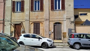 Un edificio con diverse finestre, un'entrata e un piccolo ingresso.