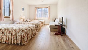 A spacious bedroom with two beds, a desk, and a computer. - KANALIAN HOTEL (Nagawa)
