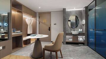 Relax in a stylish space with a round dining table, wardrobe, and large mirror.