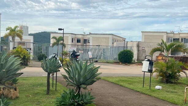 A gated residential area with buildings, a paved road, and some greenery including agave plants. - 2Next Confins Airport, Cid Galo, 15minBH, Mega Space  (Centro Vespasiano)