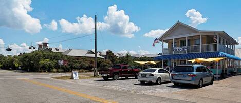 A beachfront building with a blue awning and a sign for Blue Mountain Beach Creamery.