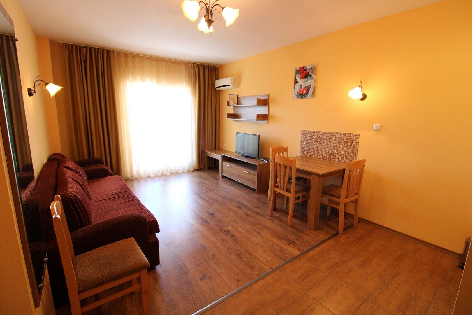 A compact room with a bed, a desk, and a television.