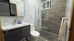 Shower, hair dryer, towels, toilet paper