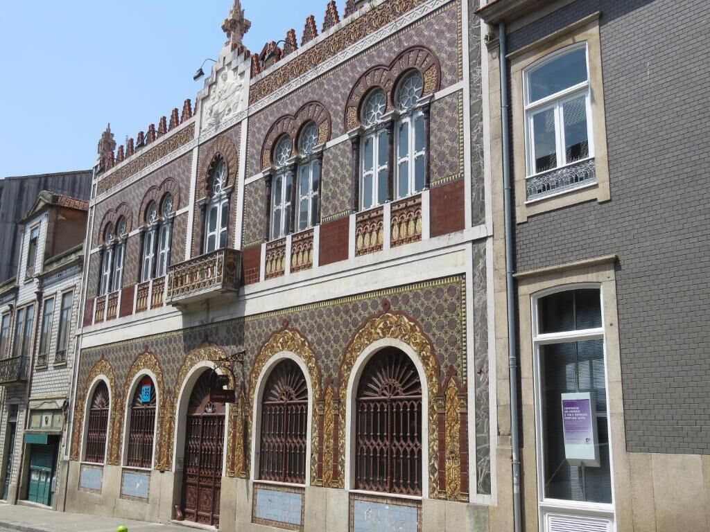 A historic building with ornate architectural details, including arched windows and decorative patterns.