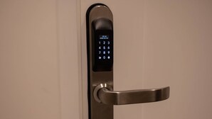 A modern door lock with a digital keypad and a metallic handle. - Your room like in a 4-star Hotel (Roma)