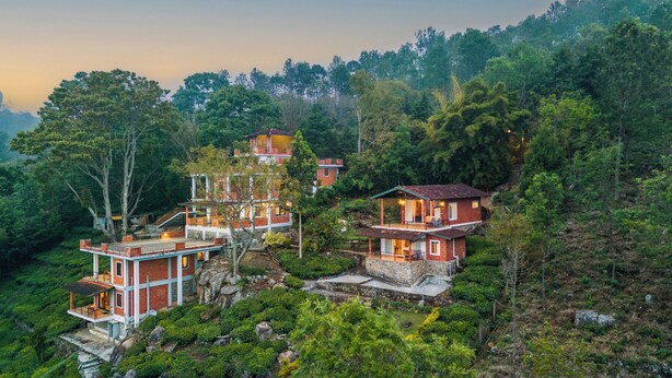 A multi-story house with a balcony, surrounded by lush greenery and trees. - Lazy Hills by Xplore Indo (Kotagiri)