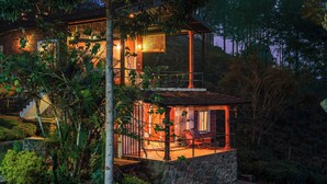 A two-story house with a balcony, surrounded by lush greenery. - Lazy Hills by Xplore Indo (Kotagiri)