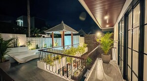Enjoy the serene outdoor space with a balcony, potted plants, and a shaded area.