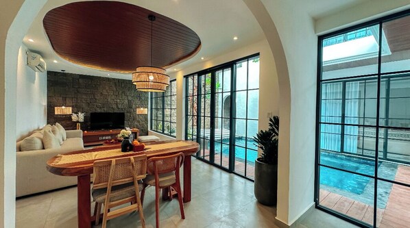 Relax in this open-plan living space with a central island, flat-screen TV, and comfortable seating area.