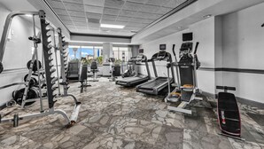 A gym with treadmills, weight machines, and a stationary bike. - Bluewater Resort 1012 (Myrtle Beach)