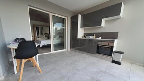 A modern kitchen with grey cabinets and a built-in oven.