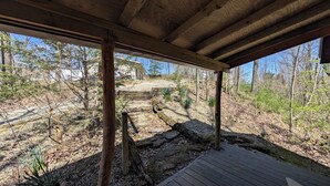 A wooden deck with a stone pathway leading to a house. - Quaint Cabin w/ Elevated Back Deck Among the Trees (Laurelville)