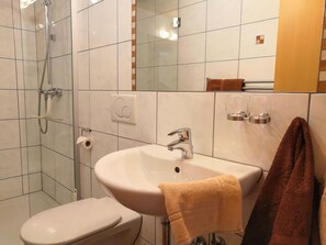 Shower, hair dryer, towels, toilet paper
