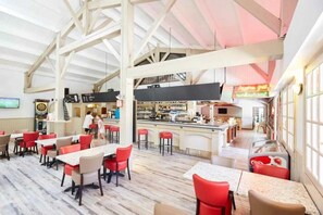 Enjoy meals in our spacious dining area with high ceilings and large windows.