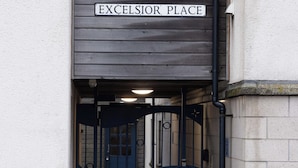 A gated entrance to a building with a sign reading "Excelsior Place". - Lerwick Penthouse Apartment (Lerwick)
