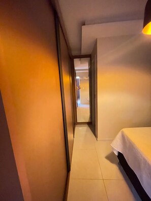 Enter a serene bedroom with a single bed and minimalist design.
