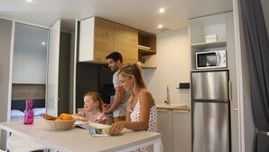 Una cocina moderna con una mesa de comedor, microondas y refrigerador.