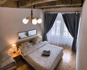 Family Apartment, City View | Desk, laptop workspace, blackout drapes, iron/ironing board - At the Blue Lion & Parking Assistance (Prague)