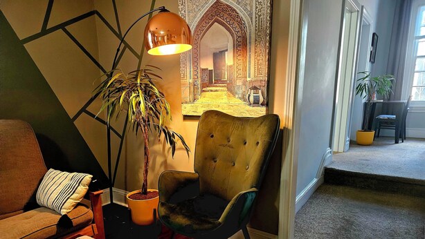 A living room with a sofa, armchair, and a potted plant. - Loft • King Bed • Free Parking • Early Check in 2pm / 12pm Late Check Out (Pottstown)