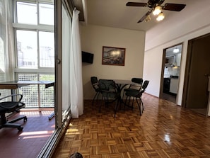 Enjoy meals at the dining table with four chairs, and relax in the room with a ceiling fan.