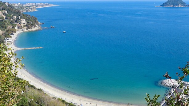 A coastal view with a beach, clear blue waters, and a distant island. - 1 bedroom amazing home in Onzo (Onzo)