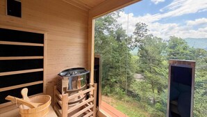 A wooden interior with a view of a forest and mountains. - 5 mi. to Asheville•HotTub•Sauna•MtnViews•FirePit•PoolTable (Swannanoa)