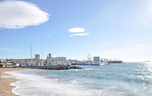 A coastal cityscape with a beach, marina, and buildings including a prominent tower. - Pet friendly apartment in Fréjus with WiFi (Fréjus)