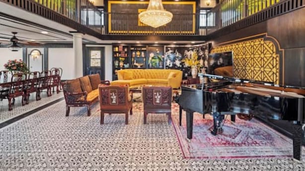 A spacious lobby with a grand chandelier, a piano, and a yellow sofa. - Fruit Trees, Farm Stay, Ranch Retreat, Lake Access (Fallbrook)