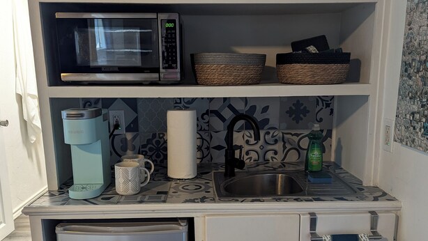 A compact kitchenette with a microwave, coffee maker, and a small refrigerator. - The Half Pint - Pet Friendly for 1 Pet Only (Abilene)