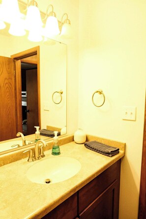 A bathroom with a sink, mirror, towel rings, and a towel rack. - Slope Side Winter Villa I Alpen Villas at Powderhorn Mountain (Bessemer Township)