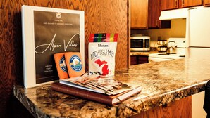 A kitchen counter with a framed thank you card, a Shurms Michegummie bag, and a notebook. - Slope Side Winter Villa I Alpen Villas at Powderhorn Mountain (Bessemer Township)